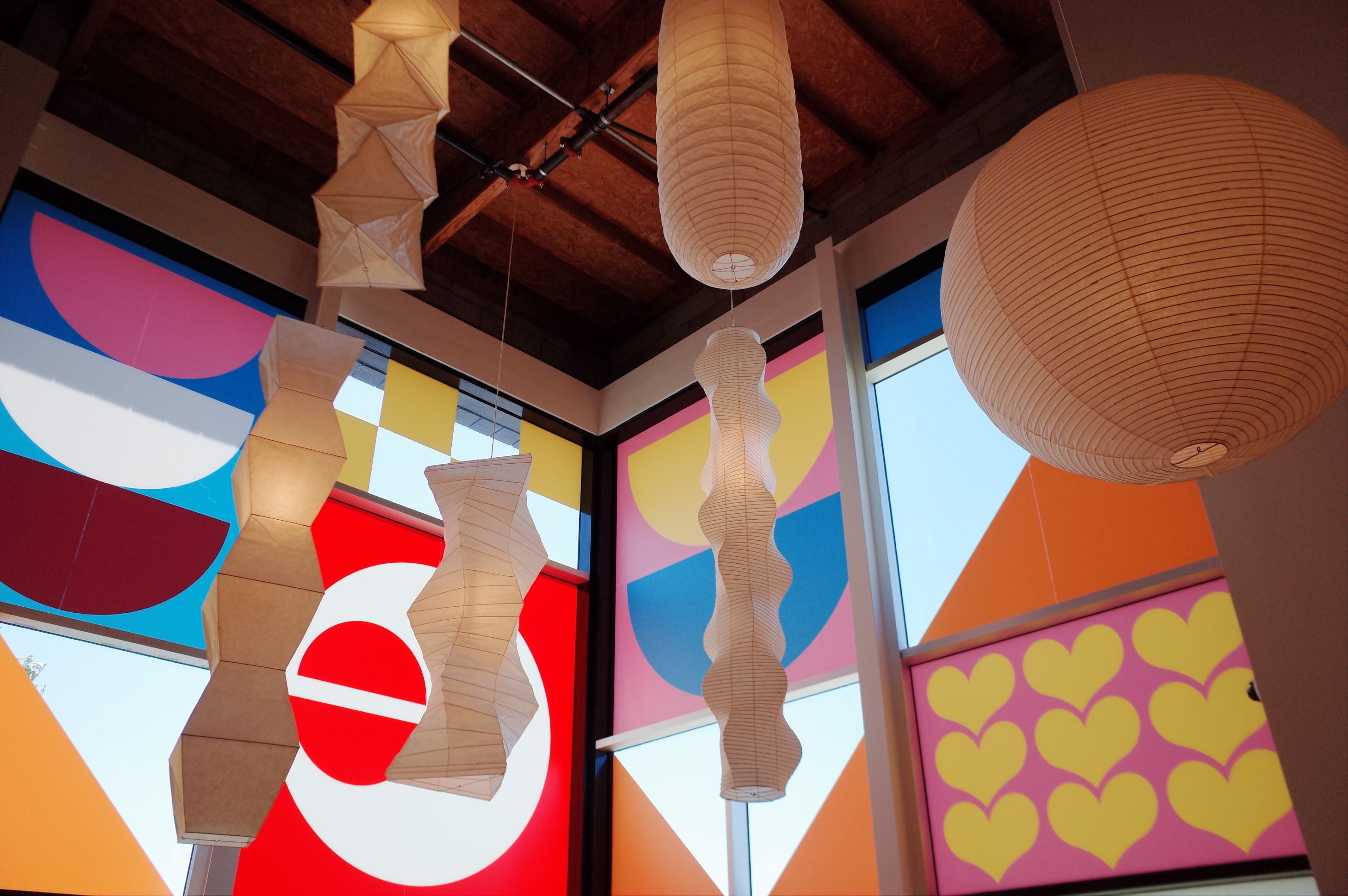 Sculptural paper lanterns against a mural