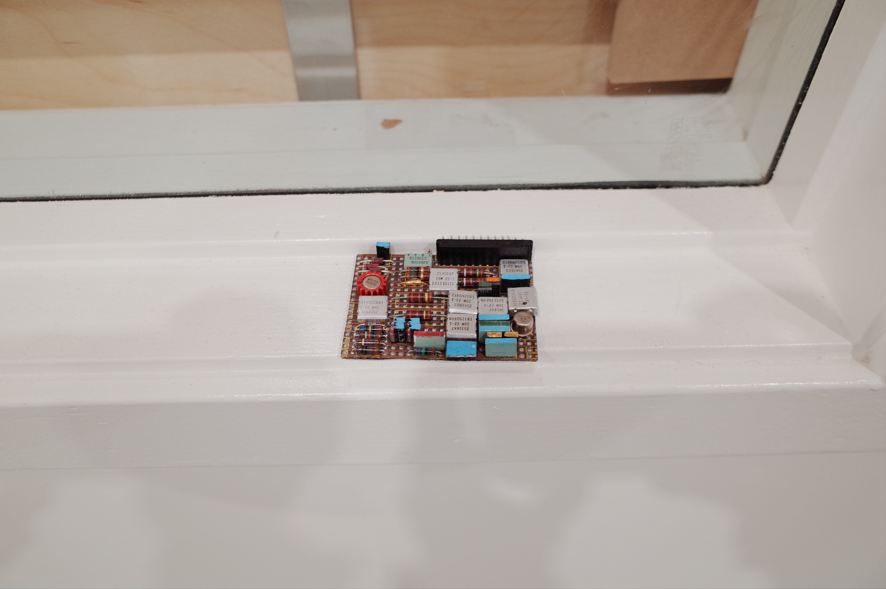 Circuit board study piece on a windowsill