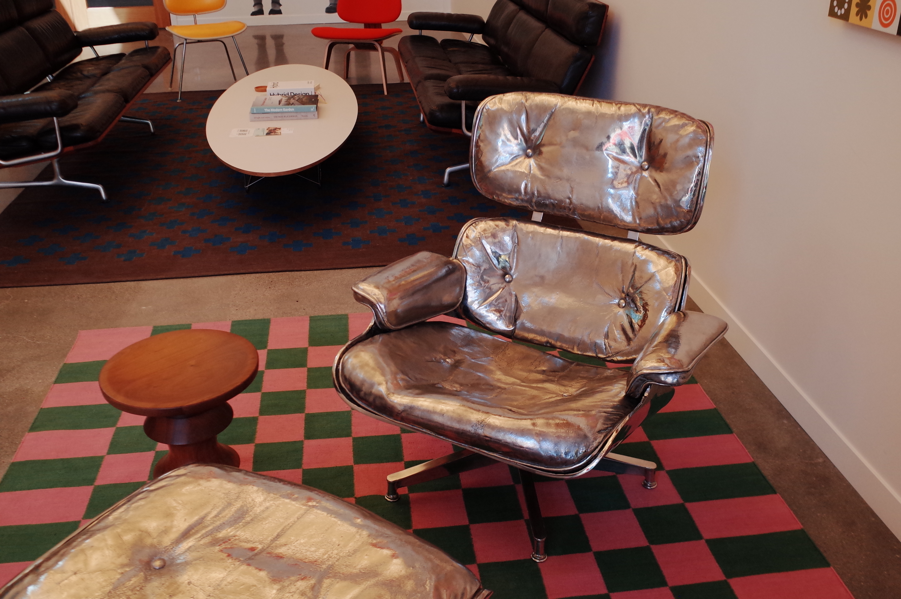 A weathered Eames lounge chair and ottoman